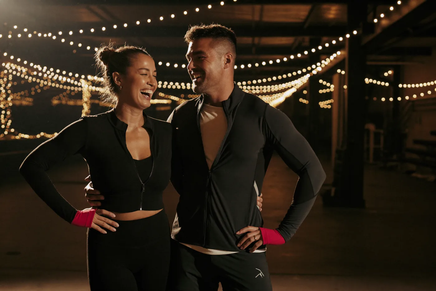 Fit couple laughing after training